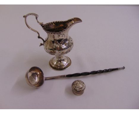 A George III silver cream jug baluster form, the sides chased with windmills, punch bead border, double scroll handle London 