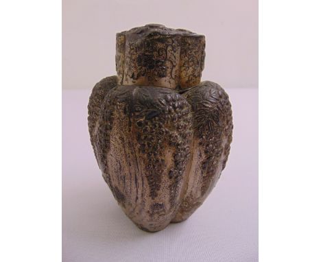 A Chinese white metal tea caddy, ovoid form with foliate relief decoration, character marks to base