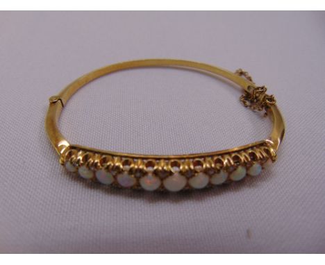 A gold, opal and diamond bangle, gold tested 18ct, approx total weight 16.9g