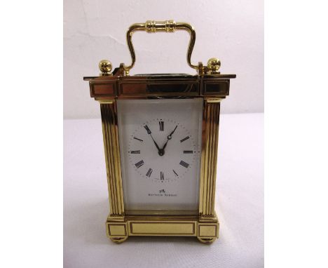 A Matthew Norman brass carriage clock flanked by fluted columns and with carrying handle