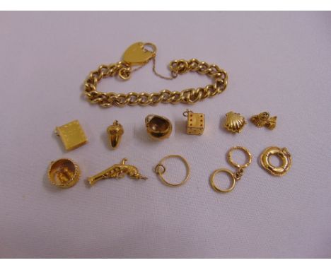 Ten 9ct gold charms approx total weight 17.8g, a 22ct gold ring approx total weight 1.4g and a gold plated charm bracelet