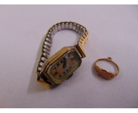 A ladies 9ct gold dress watch with mother of pearl dial and expandable gold plated bracelet and a 9ct yellow gold childs ring