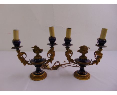 A pair of French enamel and gilded metal two light candelabra converted to electricity