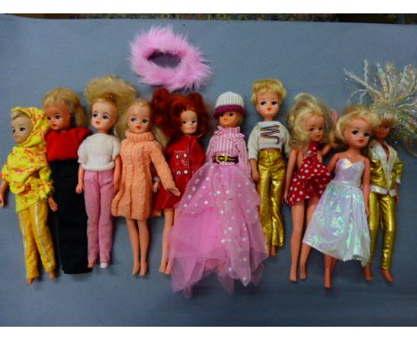 Ten vintage Sindy dolls with outfits including 1960's