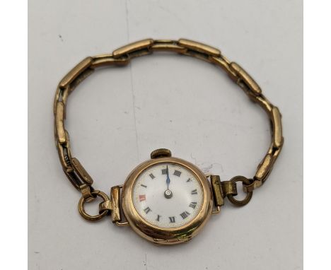 A 9ct gold manual wind wristwatch on a gold plated braceletLocation: 