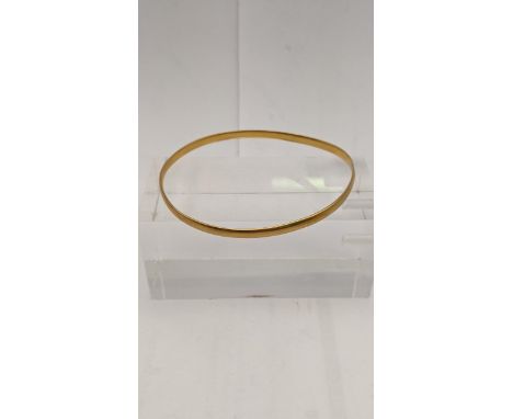 A yellow metal bangle, testing as 18ct gold, total weight 10.9g Location: 