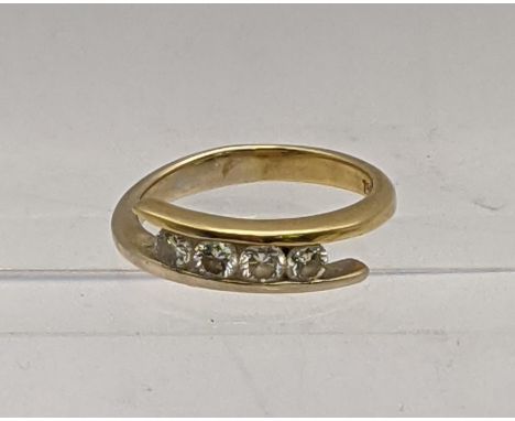 An 18ct gold ring inset with four diamonds, total weight 4.1g Location: 