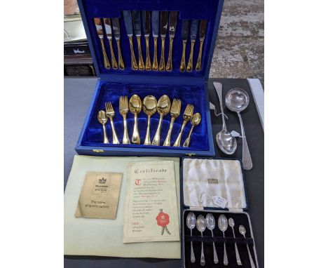 A Bestecke Solingen chrome nickel steel cutlery set with gilt handles, cased set of four Edwardian silver teaspoons and match