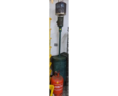A vintage green painted patio heater with metal disc shade, and a propane Calor Gas bottle, along with a folding extendable a