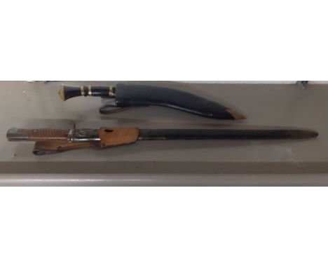 An early 20th century bayonet, together with a kukri in a leather scabbard Location:BWR 