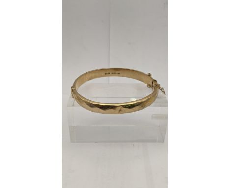 A hinged and clasped 9ct gold bangle, total weight  12.8gLocation: 