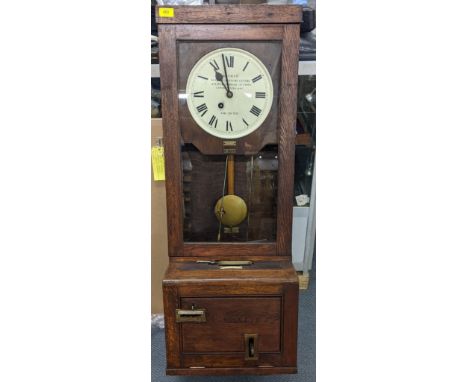 An early/mid 20th century oak carved clocking-in clock, the dial inscribed Boyhan Office Furniture Centre 115cm h x 40cm w Lo