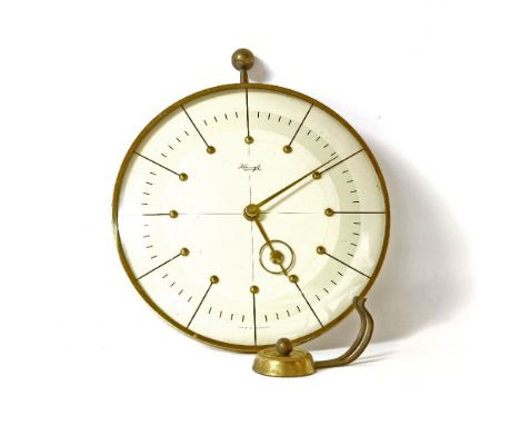 An Art Deco Kienzle brass cased wall clock and bracket, the circular dial with stylised hands, 22cm diameter