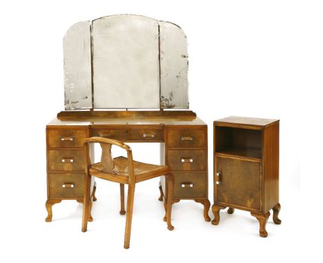 An Art Deco walnut dressing table, with a bevelled edge triptych mirror, over seven drawers with chrome rectangular handles, 