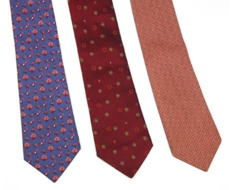 Three Hermès silk ties, to include a blue silk ground tie with a printed pink peacock design, a red silk ground tied with a w