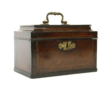 A Chippendale style mahogany and crossbanded tea caddy, the moulded top with a gilt brass handle, opening to reveal a fitted 