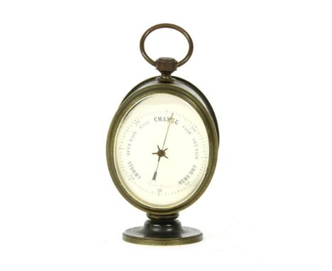 A lacquered brass desk aneroid barometer, late 19th century, the white dial with black markings and on a turned brass foot, 1