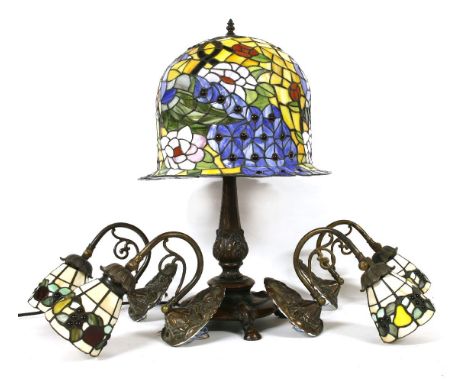 A Tiffany design table lamp with faux stamped glass shade on naturalistic base, 61cm high, together with a set of similar wal