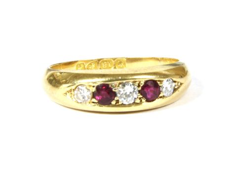 An 18ct gold graduated five stone ruby and diamond ring, grain set to a tapering plain polished shank, 4.47g, size M½