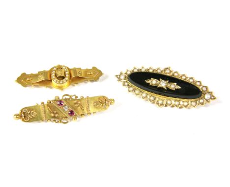 Three Victorian brooches, to include a Victorian 15ct gold three stone diamond and ruby bar brooch, (pin tests as a lower car