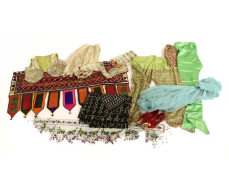 A collection of early 20th century Indian textiles, comprising an Indian child's waistcoat, highly embroidered with metallic 