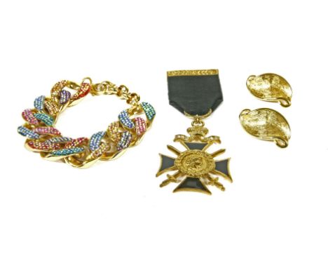 A Butler and Wilson Swarovski crystal curb link bracelet, a Butler and Wilson black enamel and paste medal with ribbon and br