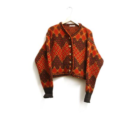 A collection of vintage designer clothes to include a vintage Yves Saint Laurent Aztec wool cardigan in red, brown and mustar