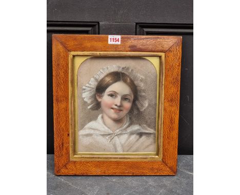 British School,&nbsp;second quarter 19th century, head and shoulders portrait of a young lady wearing a bonnet, pastel, 26 x 