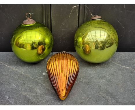 Two antique green glass witches' balls, largest 14cm diameter; together with a vintage French ribbed glass cone, 16cm high. (