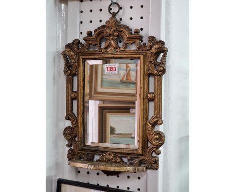A Victorian gilt painted cast iron framed wall mirror, with apron shelf, 36 x 25cm. 