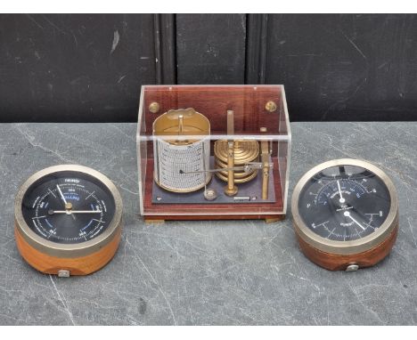 A small barograph,&nbsp;by Plastimo, 17.5cm wide; together with a barometer set, by Taylor, 12cm diameter. (3) 