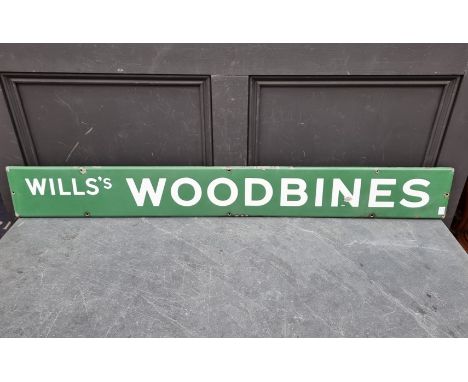 Advertising:&nbsp;a vintage enamel 'Wills's Woodbines' sign, 15 x 121.5cm. 