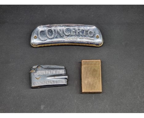 A Dupont gilt lighter;&nbsp;together with another Ronson lighter; a Halex whistle; and a Tri-ang Concerto harmonica. (4) 