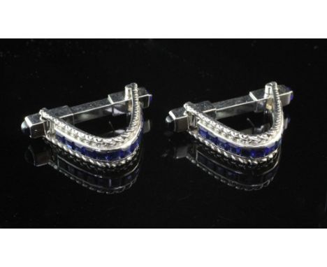 A pair of French 18ct white gold and sapphire cufflinks, of loop form, with channel set sapphires and cabochon terminals, gro