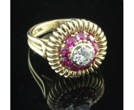 A 1960's? continental gold, diamond and synthetic ruby target dress ring, with pierced setting, the central diamond weighing 