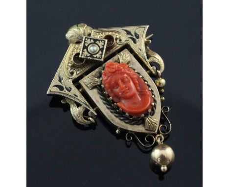 A Victorian gold, split pearl, black enamel and coral set drop pendant brooch, the coral panel carved with the bust of a lady