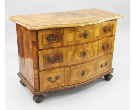 An 18th century German marquetry inlaid walnut serpentine commode, with three long drawers, on turned feet, W.3ft 8.5in.