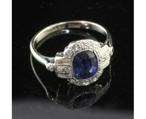 A 1930's Art Deco 18ct white gold and platinum, sapphire and diamond cluster ring, set with cushion cut sapphire and baguette