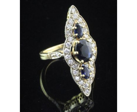 A French 18ct gold, sapphire and diamond up-finger ring, of shaped marquise form, with diamond set shoulders, size K.