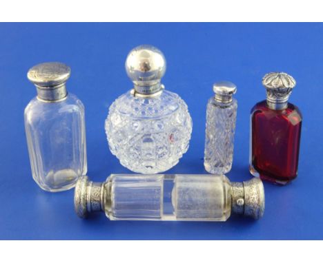 Five assorted Victorian and later mounted glass scent bottles, four with silver mounts including ruby glass and an unmarked d