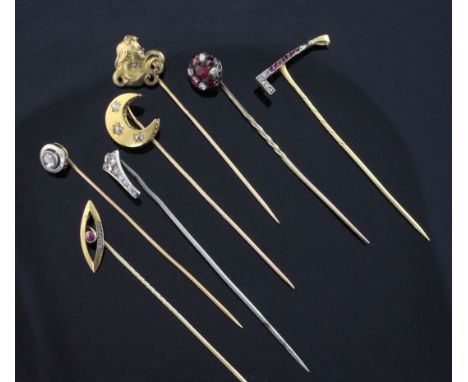 Seven early 20th century assorted gem set stick pins, including French 18ct gold riding crop, a similar diamond set crescent 