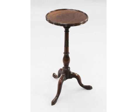 A George III mahogany tripod wine table, with circular dished top, on baluster turned column with downswept supports and poin