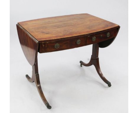 An early 19th century oval crossbanded mahogany sofa table, with single drawer and dummy drawer opposing similar single drawe