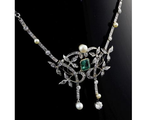 An Edwardian platinum and 18ct gold, emerald, diamond and pearl drop necklace, of scrolling foliate design, with detachable c