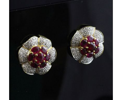 A pair of gold, ruby and diamond flowerhead earrings.