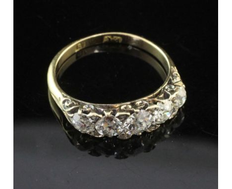 An early 20th century 18ct gold and graduated five stone diamond half hoop ring, set with old and rose cut diamonds, size M.