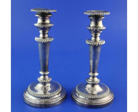 A pair of George III silver candlesticks, with turned tapering stems and engraved armorial, (a.f.), John Watson, Sheffield, 1