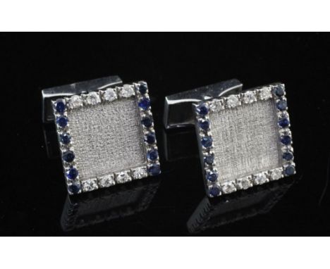 A pair of French 18ct white gold, sapphire and diamond cufflinks, of square form, with textured centre and alternating border