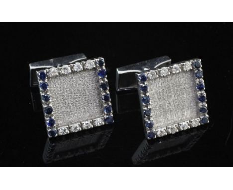 A pair of French 18ct white gold, sapphire and diamond cufflinks, of square form, with textured centre and alternating border