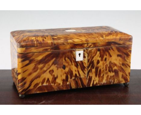 A Victorian blond tortoiseshell tea caddy, the hinged lid revealing a central space for mixing bowl and two lidded compartmen